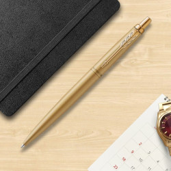 Stylo bille Parker doré en situation sur un bureau